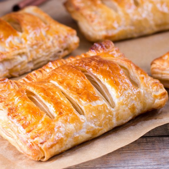 Puff,Pastry,Filled,With,Apples,On,A,Wooden,Table